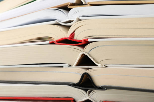 istock Stack of books on whole background, close up 1195564235