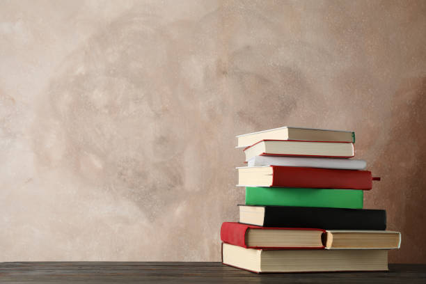 istock Stack of books against brown, space for text Stack of books against brown, space for text 1195564763