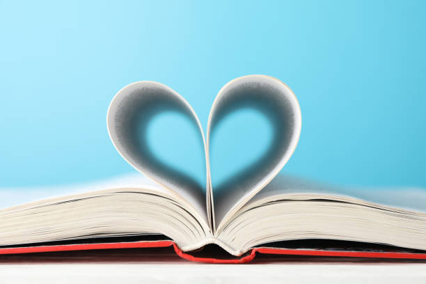 istock Heart made of pages. Book against blue background, space for text 1195564861