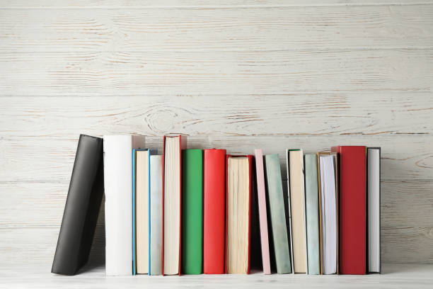 istock Books against rustic wooden background, space for text 1195564884