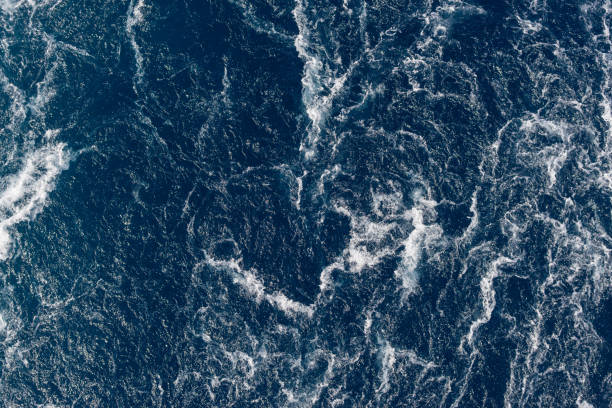 istock Full frame dark blue turbulent sea water backgrounds 1195565099