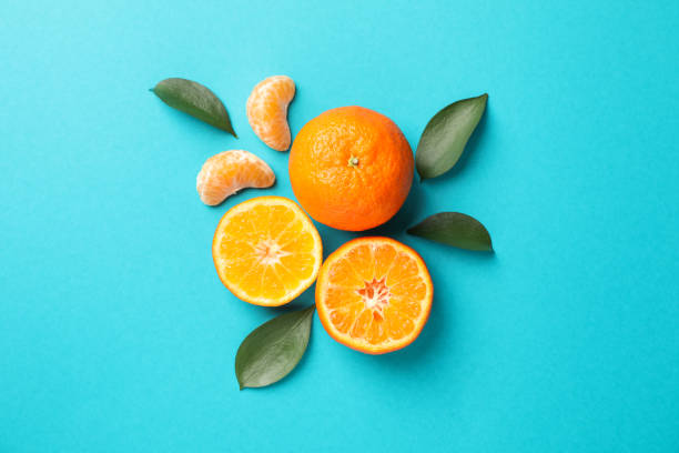 istock Delicious mandarins on turquoise background, space for text 1195565751