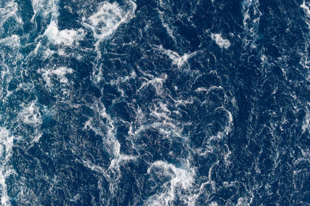 istock Full frame dark blue turbulent sea water backgrounds 1195565947