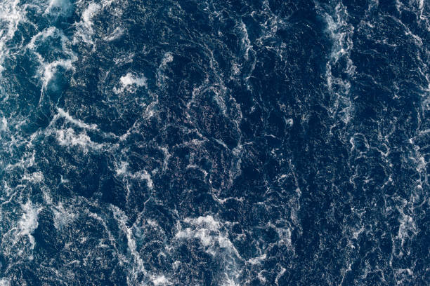 istock Full frame dark blue turbulent sea water backgrounds 1195566099