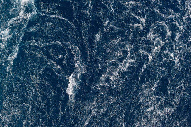 istock Full frame dark blue turbulent sea water backgrounds 1195566144