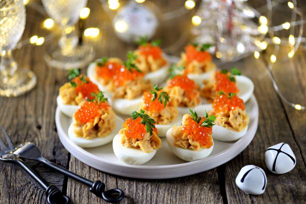 istock Stuffed eggs with salmon caviar. Christmas background. 1195567157