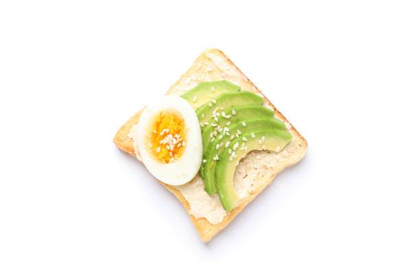 istock Toast with avocado and egg isolated on white background 1195567447