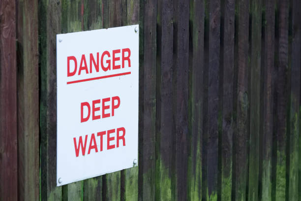 istock Deep water danger sign on sea wall 1195568602
