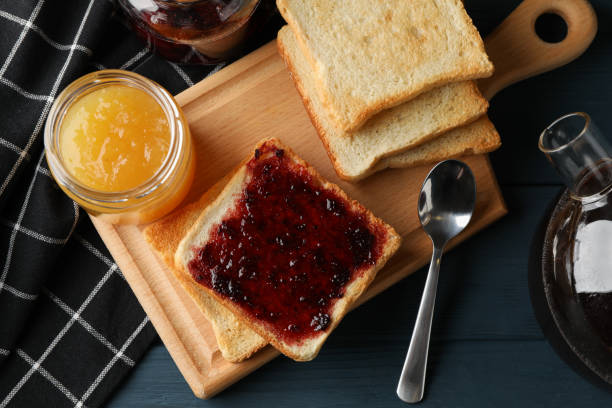 istock Toasts, jam and tea on wooden background, top view 1195568626