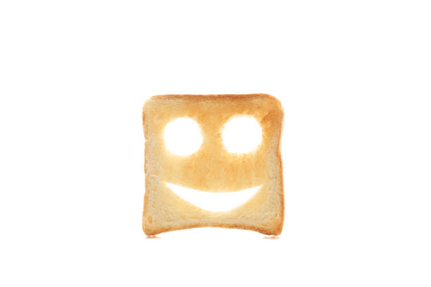 istock Tasty bread toast with happy face isolated on white background 1195568873