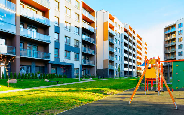 istock Apartment residential house facade architecture with children playgrounds reflex 1195569977