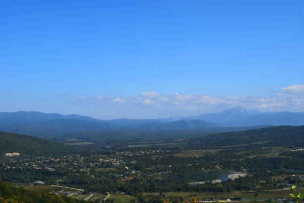 River, houses and roads in a blue haze. Horizontal photo. Adygea, Russia.
