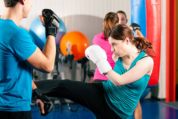 istock Female kick boxer with trainer in sparring 119557431