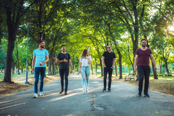 istock Friends walking in park 1195574805