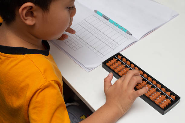 Boy counts with abacus in school Boy counts with abacus in school.Concepts of education. abacus stock pictures, royalty-free photos & images