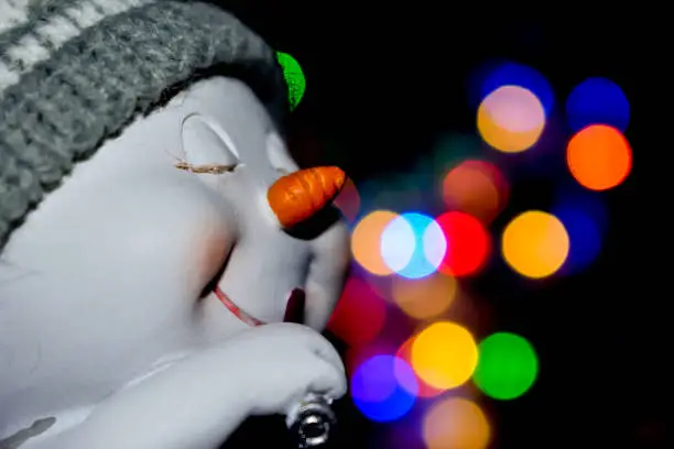 Photo of happy Snowwoman with lipstick.Snowwoman figure. Christmas deco.