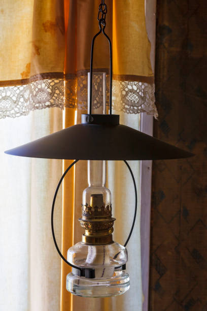 istock Kerosene lamp in a window with curtains 1195580356