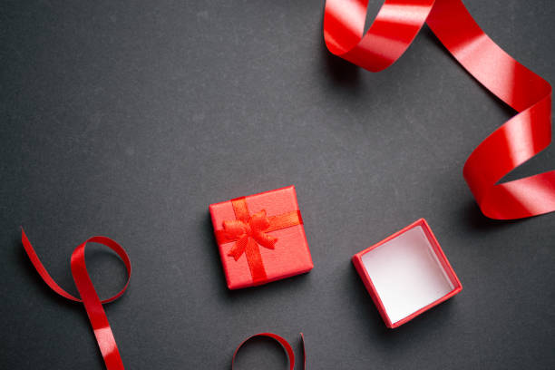 istock Top view of red gift box with many red gift bow over black background 1195580406