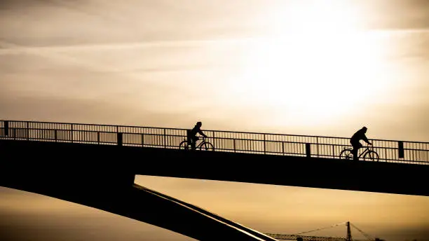 A bickrider drive down a bridge in the backlight near Cologne, Germany.