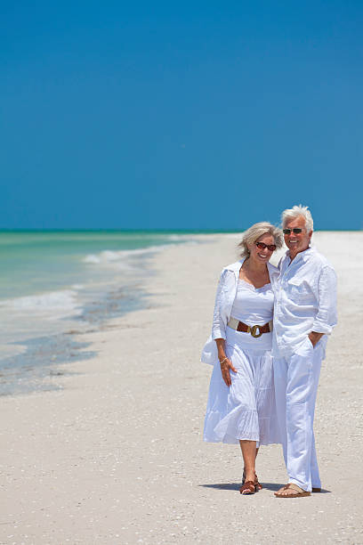 istock Happy Senior Couple Laughing on Tropical Beach 119558365