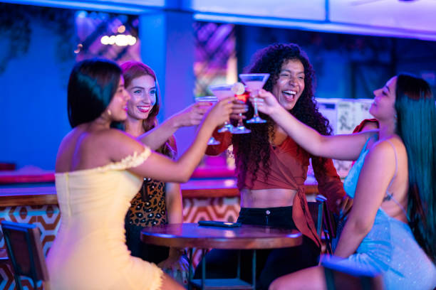 istock Girlfriends celebrating drinking cocktails inside the disco 1195584987