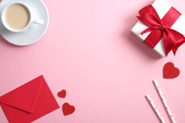 istock Happy Valentine's day concept. Flat lay composition with coffee cup, red paper envelope, gift box, Valentines hearts on pink background. Top view with copy space. 1195585737