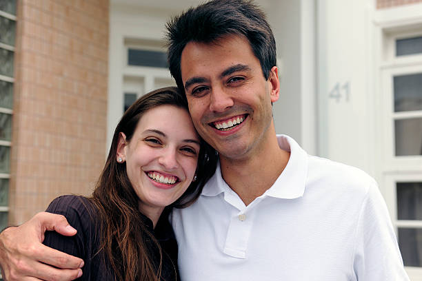 istock Real estate: Happy couple in front of house 119558635