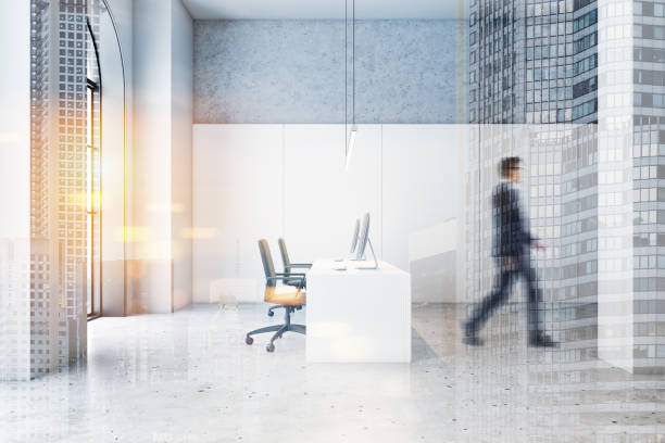 istock Businessman walking in white open space office 1195586440