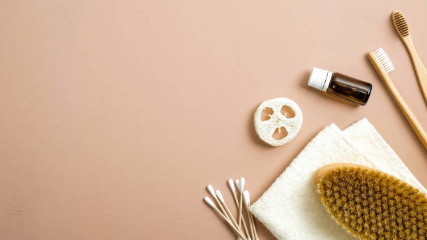istock Zero waste bathroom accessories on brown background. Eco friendly ear sticks, bamboo toothbrushes, spa brush, luffa sponge, essential oil, towel. Flat lay, top view, copy space. Plastic free concept 1195588112
