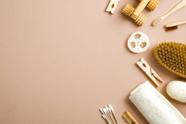 istock Flat lay zero waste bathroom items on brown background. Top view handmade soap, eco natural bamboo toothbrushes, wooden pins, bath brush and towel. Plastic free, eco friendly organic product concept 1195588168