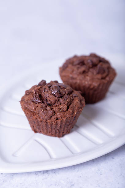 istock Chocolate muffins on a white plate. Homemade pastries. 1195590517