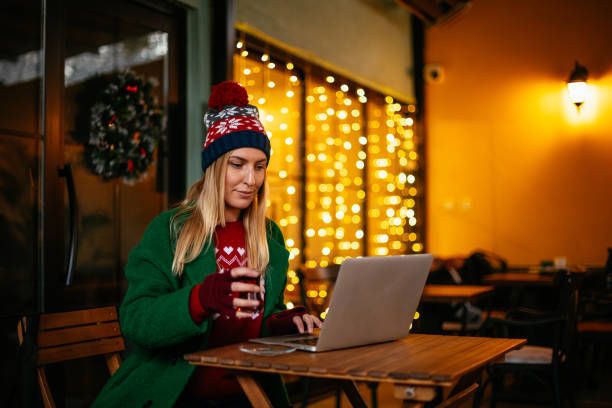 istock Urban Woman Works With Computer in Cafe 1195592570