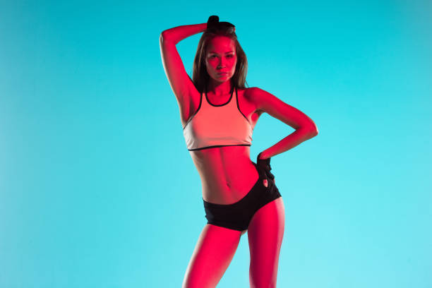 istock Muscular young female athlete on blue background 1195593839