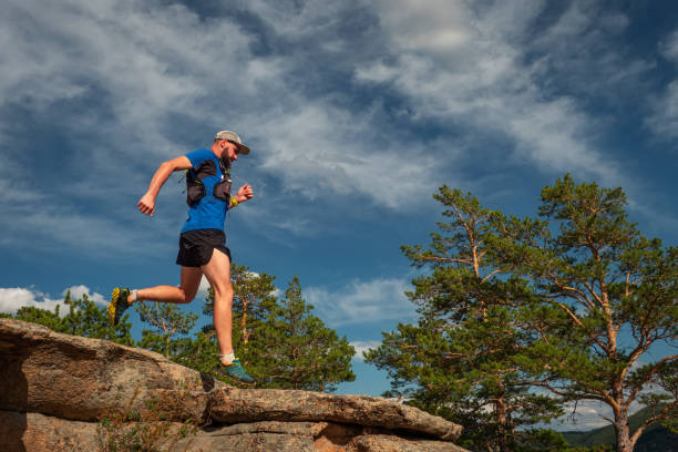 istock Male runner running on a mountain trail 1195595444