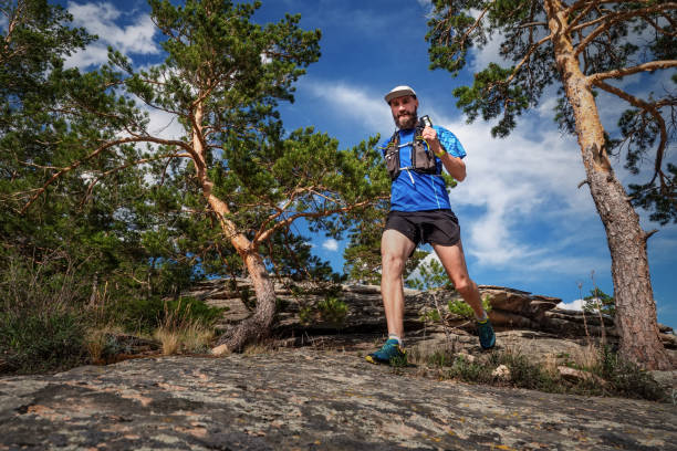 istock Male runner running on a mountain trail 1195595450