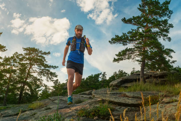 istock Male runner running on a mountain trail 1195595451