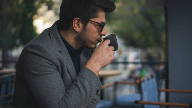 istock Businessman drinking coffee in cafe 1195595592