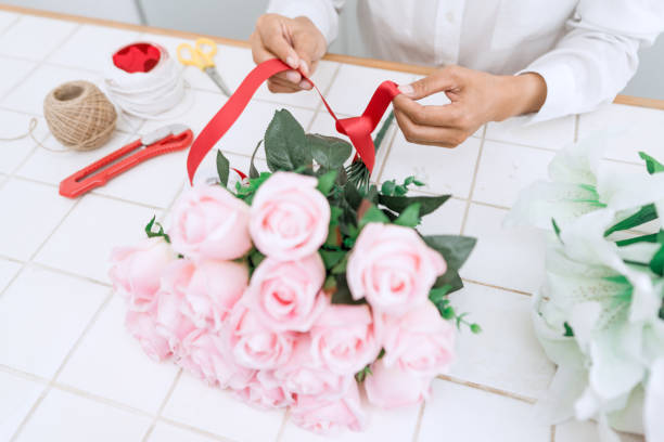 istock Midsection Of Florist With Flowers 1195598366