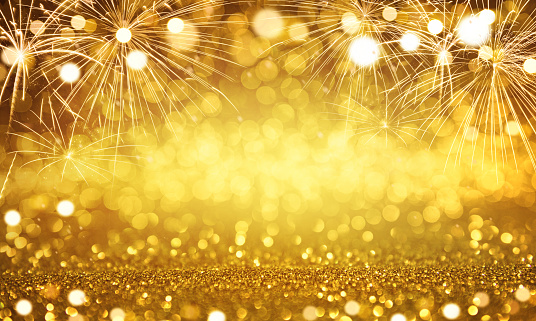 Gold fireworks and bokeh in New Year eve and copy space. Abstract background holiday.