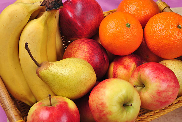 istock apple and organic orange in a basket 119560098