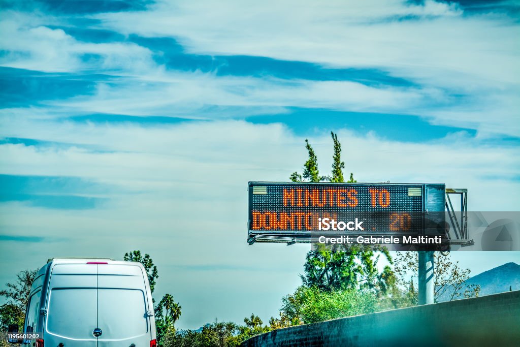 Minutes to downtown road sign in a Los Angeles freeway Minutes to downtown road sign in a Los Angeles freeway. California, USA Boulevard Stock Photo