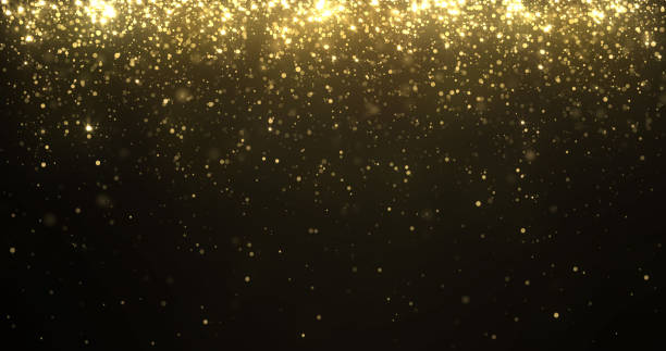 istock Gold glitter particles falling with sparkling shine light, Christmas holiday background. Magic golden glow shimmering confetti and firework glittering sparks fall with blur effect 1195604149