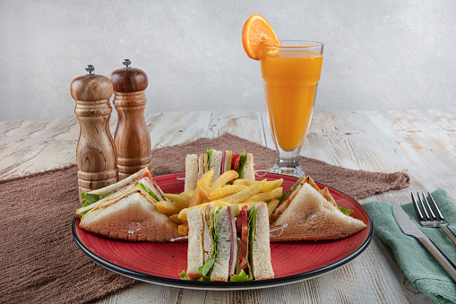American Foods - Classic Club Sandwich with French Fries.  Club sandwich restaurant concept.