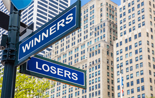 Winners losers crossroads street sign, blue color road sign. Win, lose choice decision concept. Highrise buildings background,