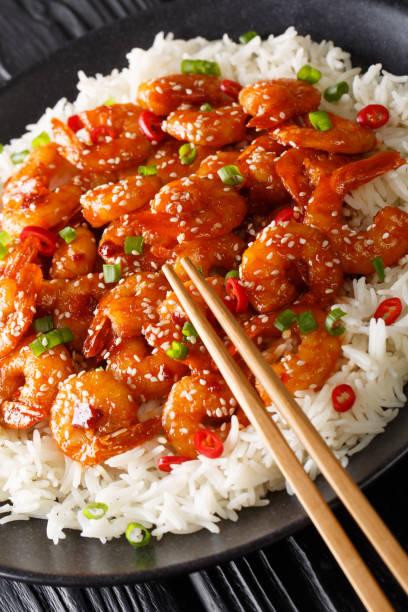 istock Asian Chilli Garlic Prawns Shrimp with rice side dish close-up in a plate. vertical 1195606230