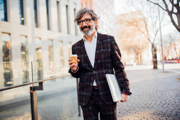 istock Mature businessman drinking coffee on his way to work 1195606661