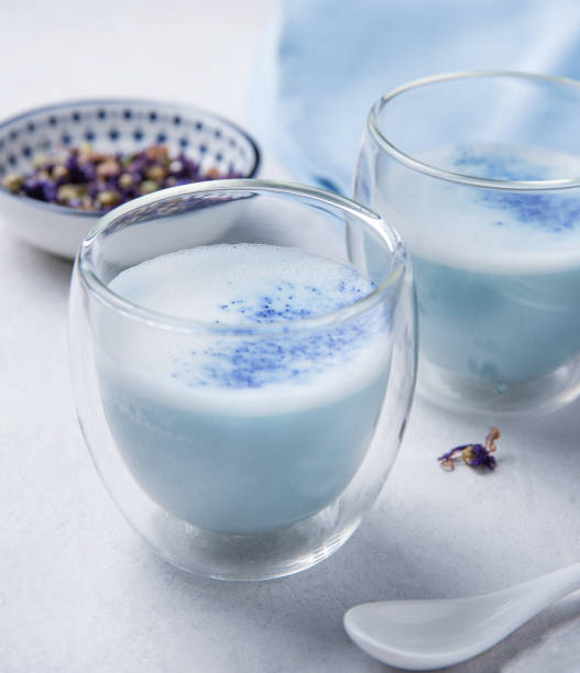 istock blue matcha tea in a clear glass on a white table