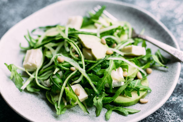 istock Vegetarian salad with arugula, fresh cucumber and avocado 1195611390