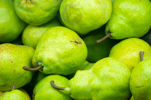 istock Green pears background on the market 1195613022