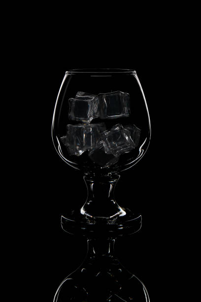 istock glass for whiskey with ice on black background 1195613920